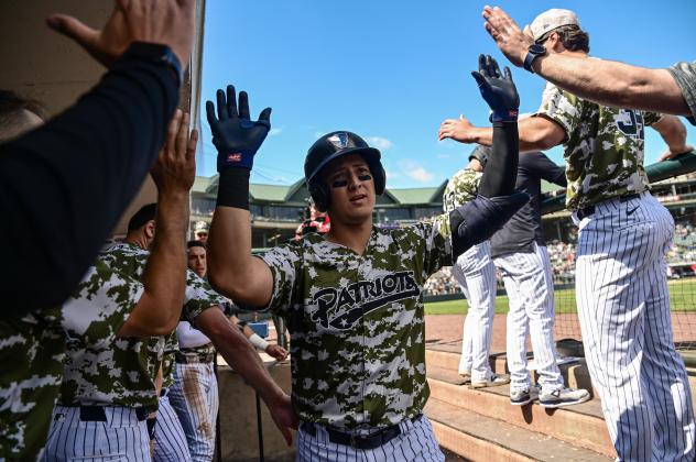 Somerset Patriots catcher Rafael Flores receives congratulations in the dugout