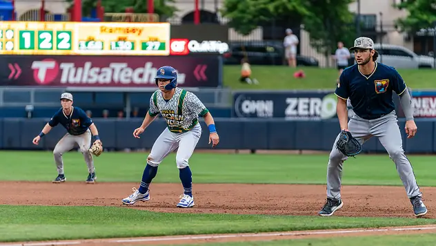 Nick Biddison of the Tulsa Oilers leads off first base