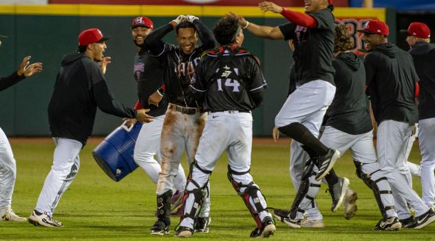 Hickory Crawdads mob Yeremy Cabrera after his walk-off hit