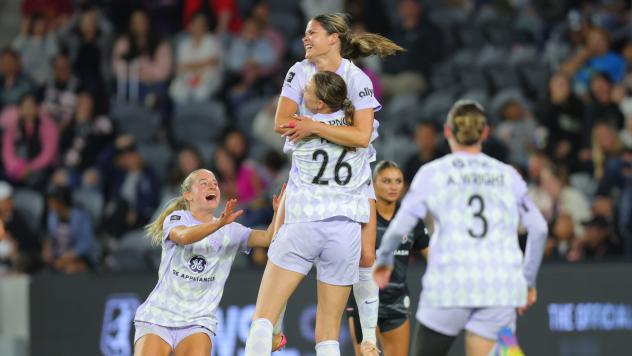 Racing Louisville FC celebrates a goal against Angel City