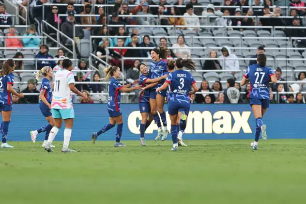 Ryan Williams (center) and the North Carolina Courage gather after their first goal