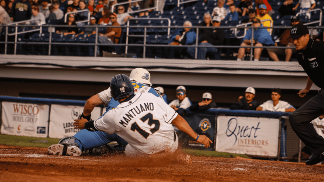 Jimmy Mantuano III of the Fond du Lac Dock Spiders slides home safely