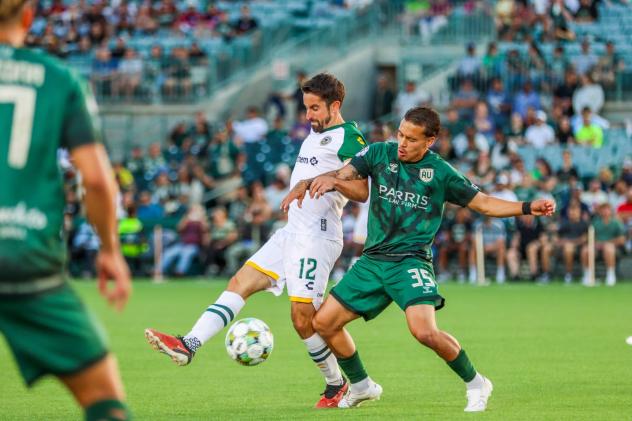 Oakland Roots SC's Tyler Gibson battles AV Alta FC's Harrison Robledo