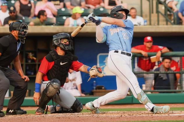 Charleston RiverDogs catcher Nathan Flewelling swings away