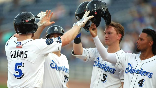 Biloxi Shuckers congratulate Luke Adams after his home