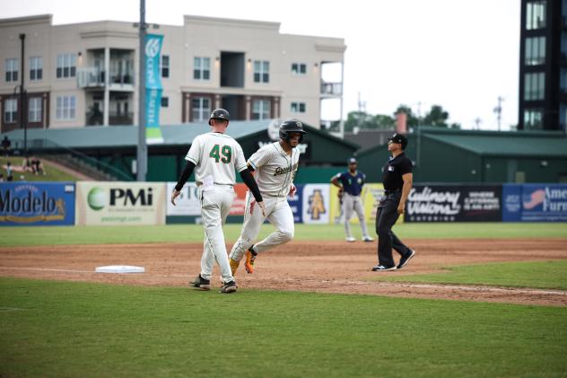Greensboro Grasshoppers' Blake Butler congratulates Omar Alfonzo