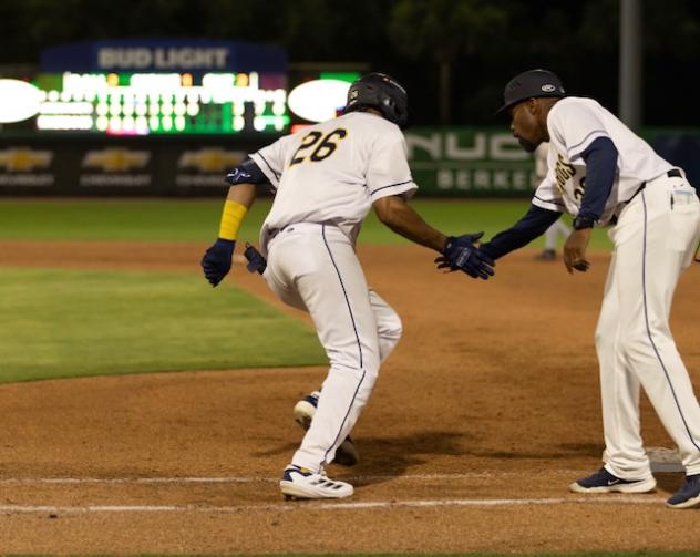 Angel Mateo of the Charleston RiverDogs receives congratulations as he rounds the bases