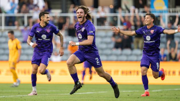 Louisville City FC defender Aiden McFadden (center) reacts after his goal