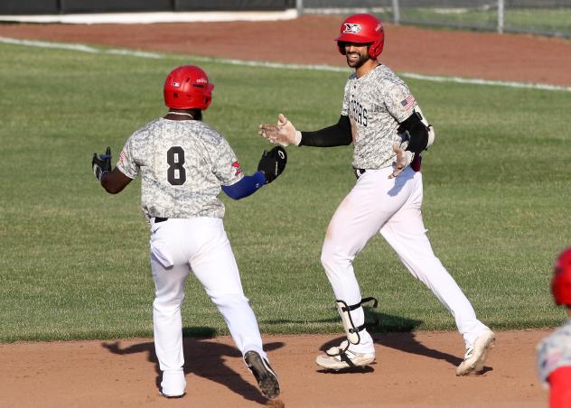 Abdiel Layer (right) of the Sioux City Explorers gets congratulated