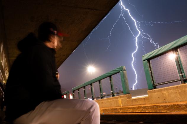 Fargo-Moorhead RedHawks watch the lightning from the dugout
