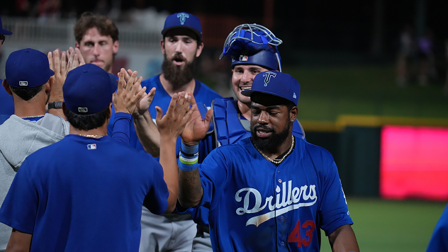 Tulsa Drillers exchange high fives after a comeback win
