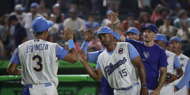 Myrtle Beach Pelicans exchange high fives with Leonel Espinoza