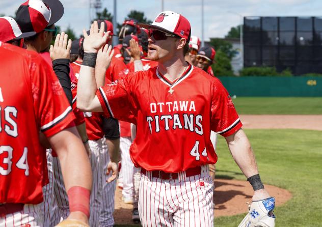 Ottawa Titans outfielder Nolan McCarthy exchanges high fives