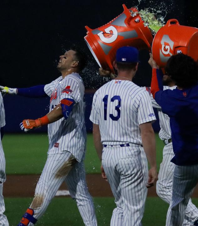 Joey Meneses gets the royal treatment from Syracuse Mets teammates