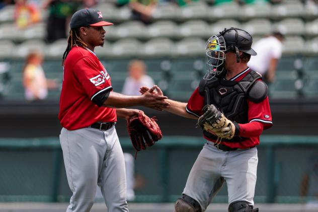 Felix Cepeda and Kurtis Byrne celebrate for the Sioux City Explorers