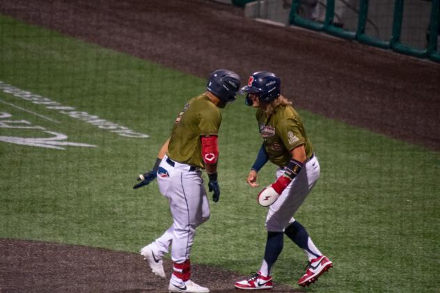 Cleburne Railroaders are in a good mood after scoring a run