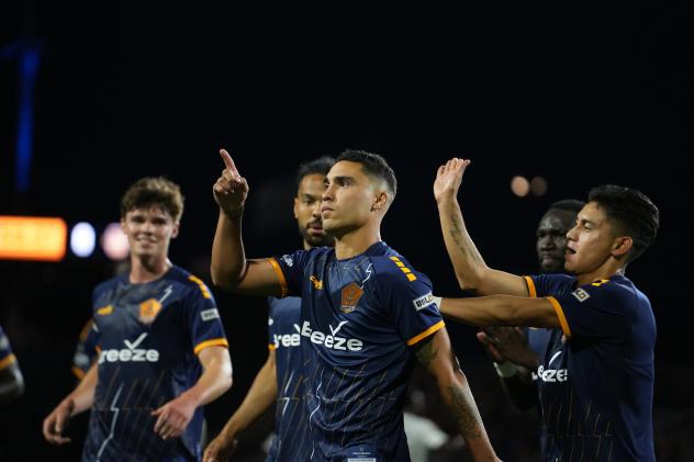Rhode Island FC congratulates Maxi Rodriguez after his penalty kick