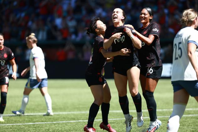 Portland Thorns celebrate a goal against the Seattle Reign