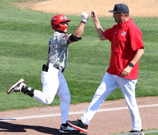Henry George of the Sioux City Explorers celebrates with Manager Steve Montgomery