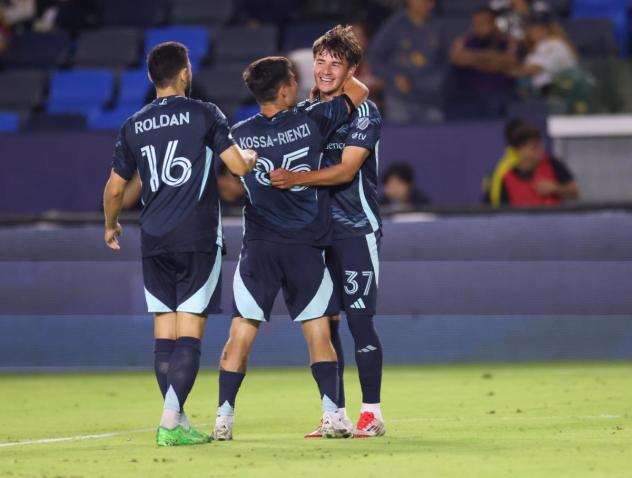 Sounders FC congratulate Snyder Brunell (far right) after his goal