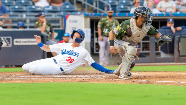 Kyle Nevin of the Tulsa Drillers slides slides safely to score