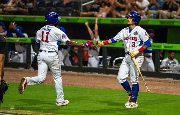 Knoxville Smokies second baseman Carter Trice (right) greets shortstop Jefferson Rojas