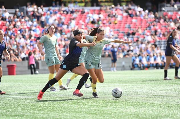 Ottawa Rapid FC and Vancouver Rise FC battle for the ball