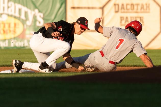 Fargo-Moorhead RedHawks apply the tag against the Winnipeg Goldeyes