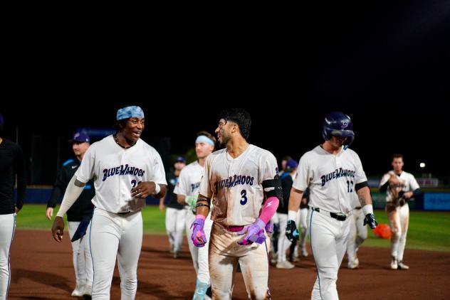 Pensacola Blue Wahoos walk off the field after a win