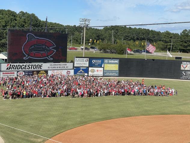Fans gather on the field after the final Carolina Mudcats home game
