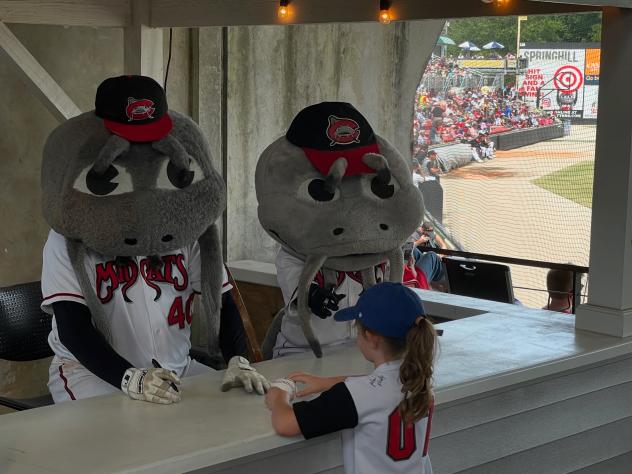 Carolina Mudcats mascots Muddy and Mini sign for the fans