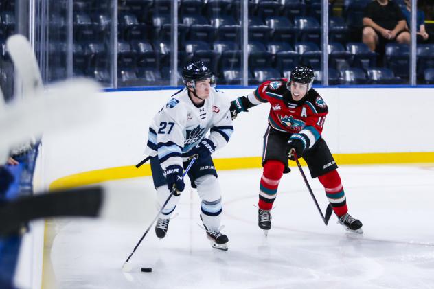 Penticton Vees right wing Corban Almen (left) vs. the Kelowna Rockets