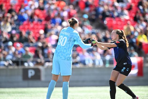 Ottawa Rapid FC goalkeeper Melissa Dagenais receives congratulations from defender Susanne Haaland