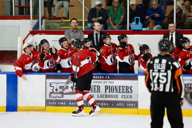 Vancouver Giants right wing Tyus Sparks receives congratulations from the bench