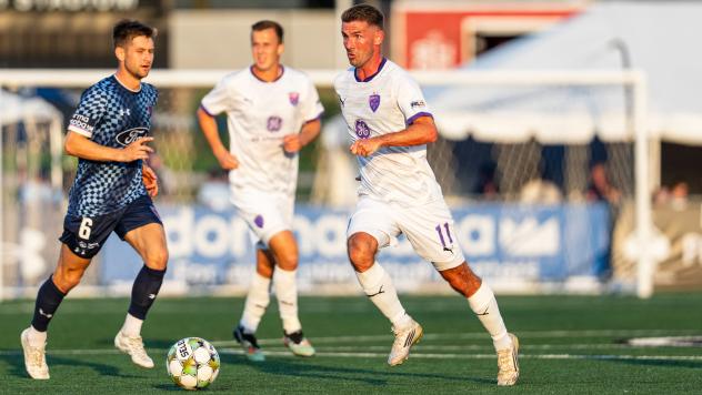 Louisville City FC midfielder Niall McCabe (right)