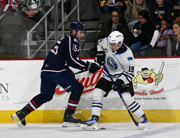 Wenatchee Wild forward Miles Cooper (right) battles for the puck