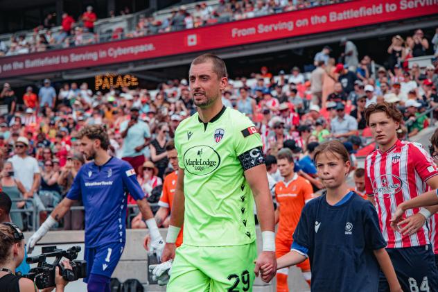Atlético Ottawa goalkeeper Nathan Ingham hits the pitch
