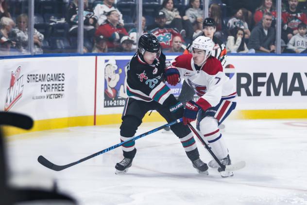 Kelowna Rockets' Eli Barrett battles Spokane Chiefs' Owen Schoettler