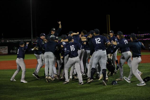 Kane County Cougars rush the field after winning the American Association championship