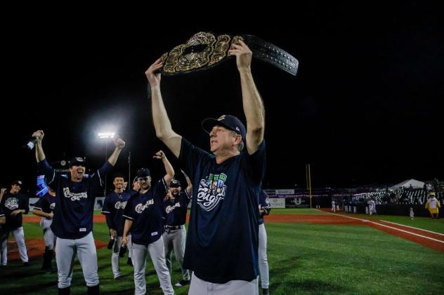 Kane County Cougars hold a championship belt aloft