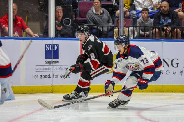 Guelph Storm's Alex Mclean and Saginaw Spirit's James Guo in action