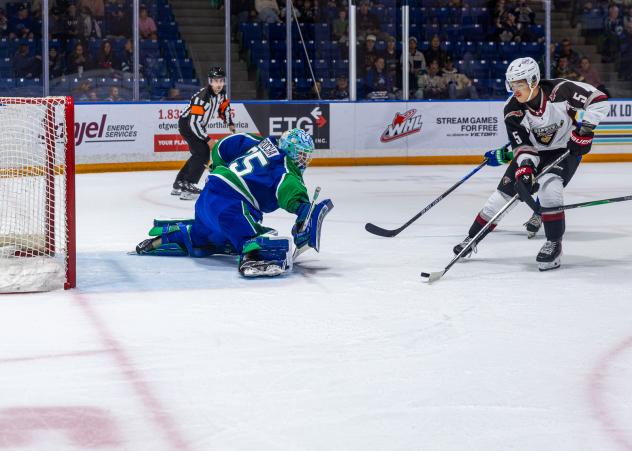Swift Current Broncos' Joey Rocha and Vancouver Giants' Tyus Sparks in action
