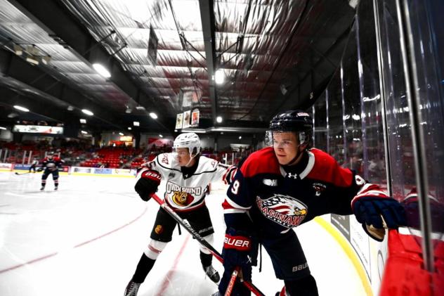 Saginaw Spirit defenseman Graydon Jones (right) vs. the Owen Sound Attack