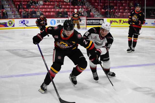 Moose Jaw Warriors' Brady Ness and Vancouver Giants' Blake Chorney in action