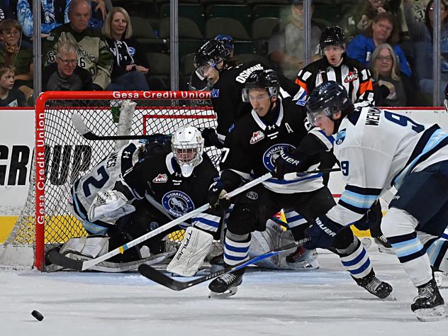 Wenatchee Wild forward Luka Shcherbyna (foreground, 27) helps to guard the net