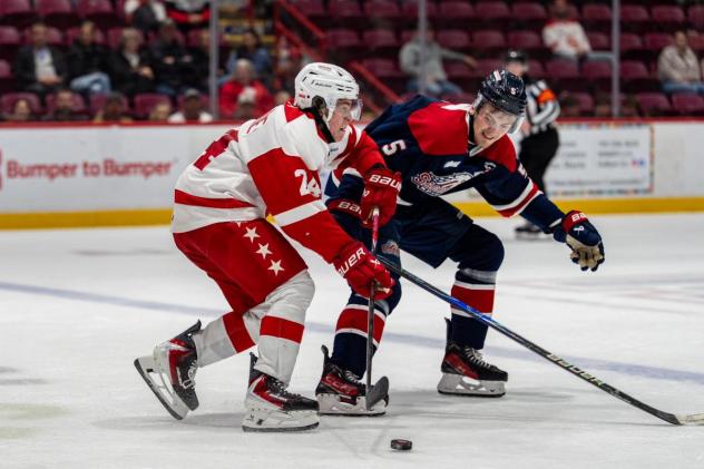 Saginaw Spirit defenseman Josh Glavin (right) vs. the Soo Greyhounds