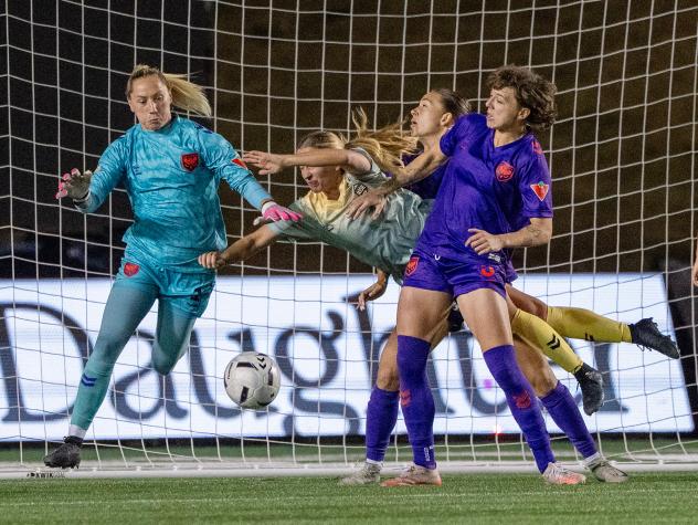 Calgary Wild FC goalkeeper Stephanie Bukovec (left) and defender Meikayla Moore (far right) vs. Vancouver Rise FC