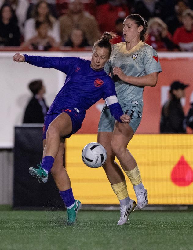 Calgary Wild FC fights for possession vs. Vancouver Rise FC