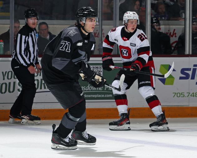 Peterborough Petes defenceman James Petrovski (left) vs. the Ottawa 67's