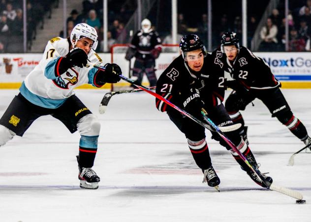 Red Deer Rebels forward Beckett Hamilton (center) and Ty Coupland (right)